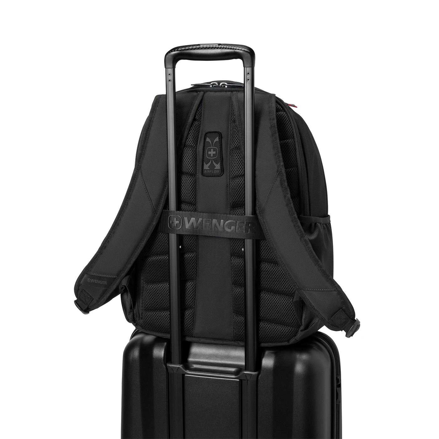 Black backpack on black suitcase, featuring the Wenger logo and airflow design.