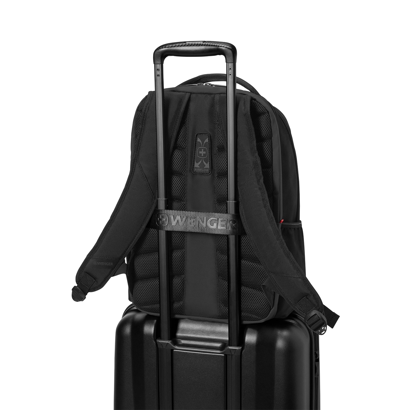 Black backpack on black suitcase with handle, Wenger logo, against black background.