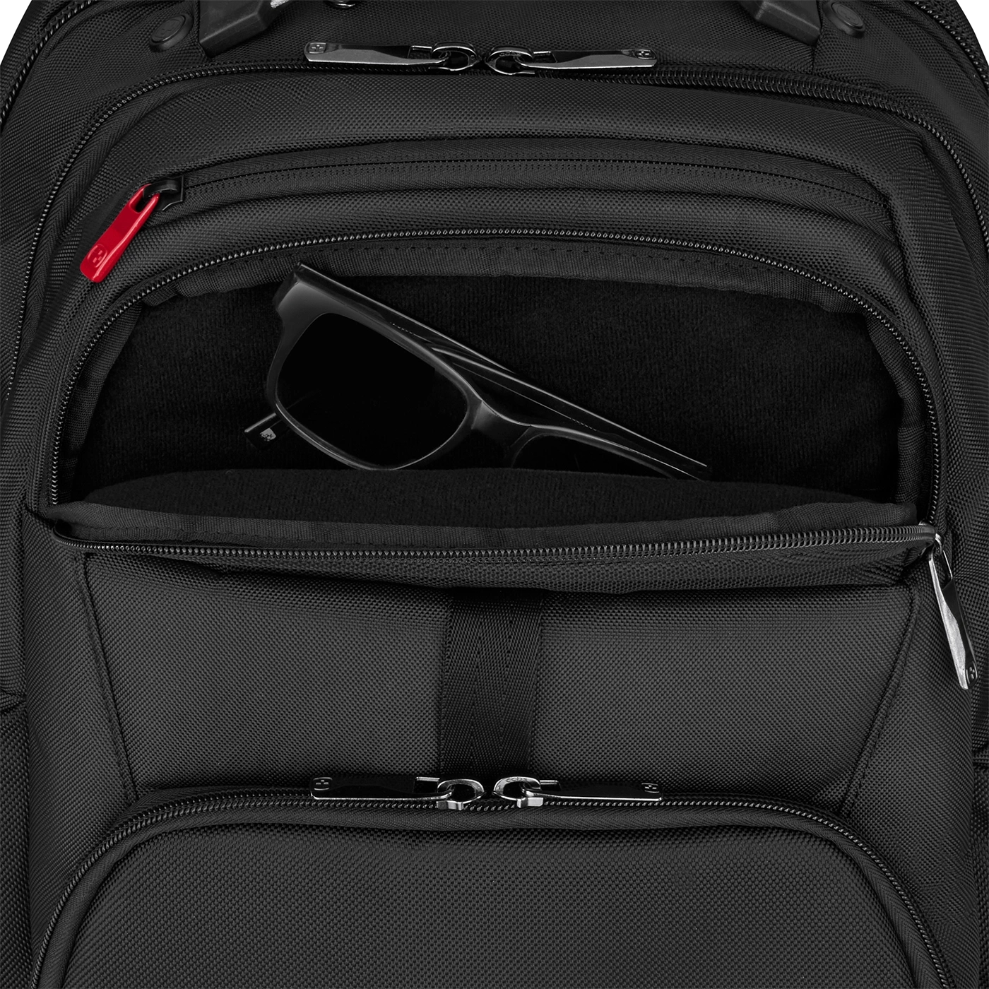 Black backpack with sunglasses in pocket, close-up shot, detail view