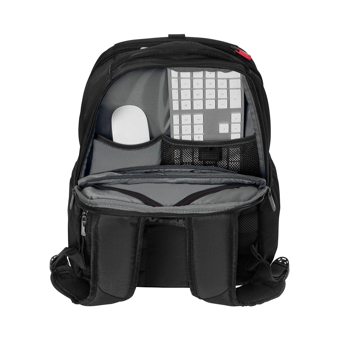 Black backpack with keyboard and mouse inside, open, against a black background.